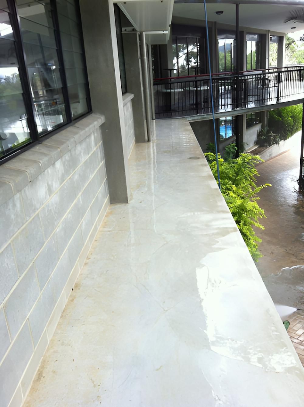 A Long Hallway With A Balcony On The Side Of A Building — EcoPro Pressure Cleaning In Broadbeach Waters, QLD