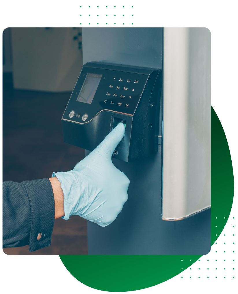 A person wearing gloves is using a fingerprint scanner for access control systems