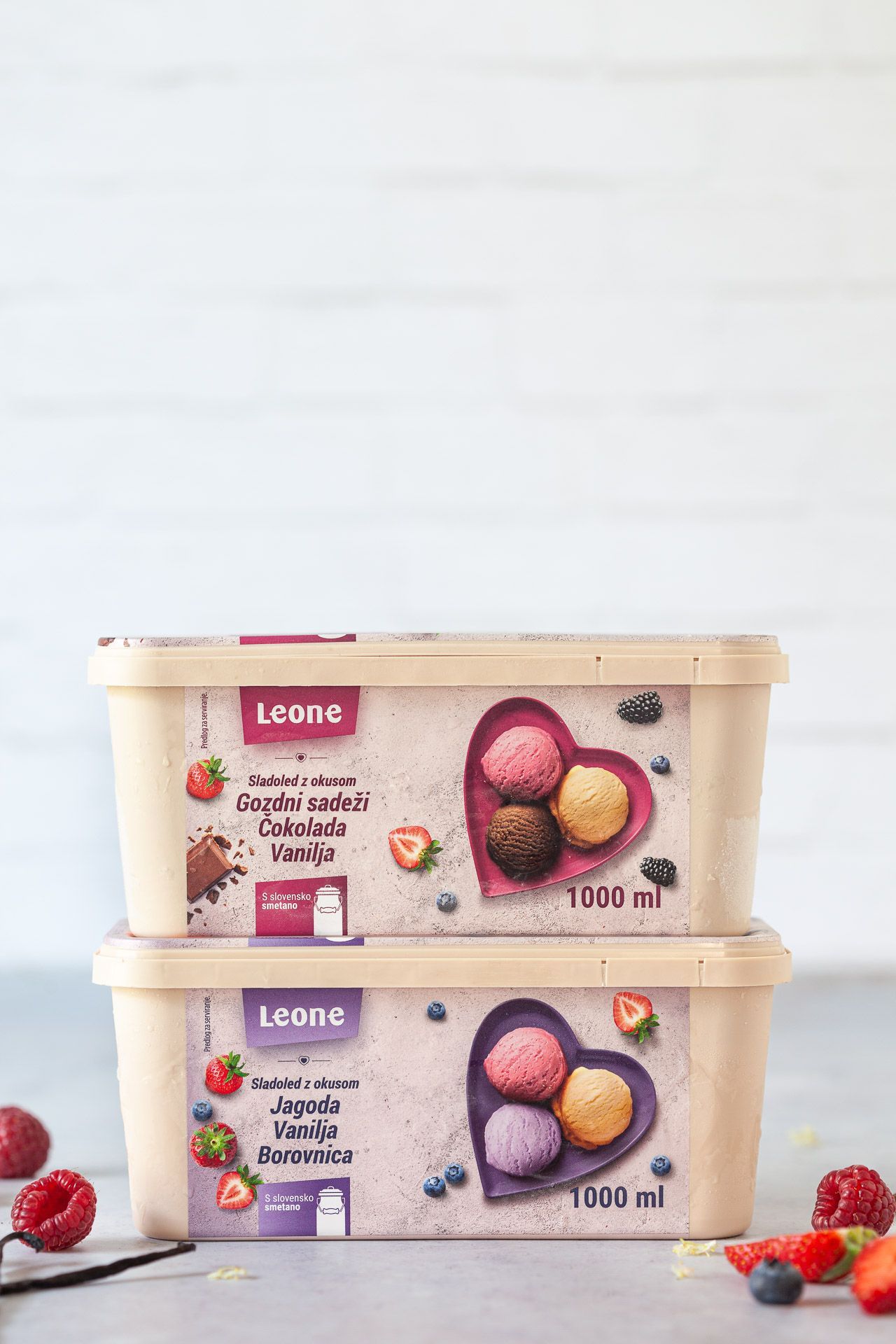 Posodica sladoleda leone, obdana z jagodami in borovnicami