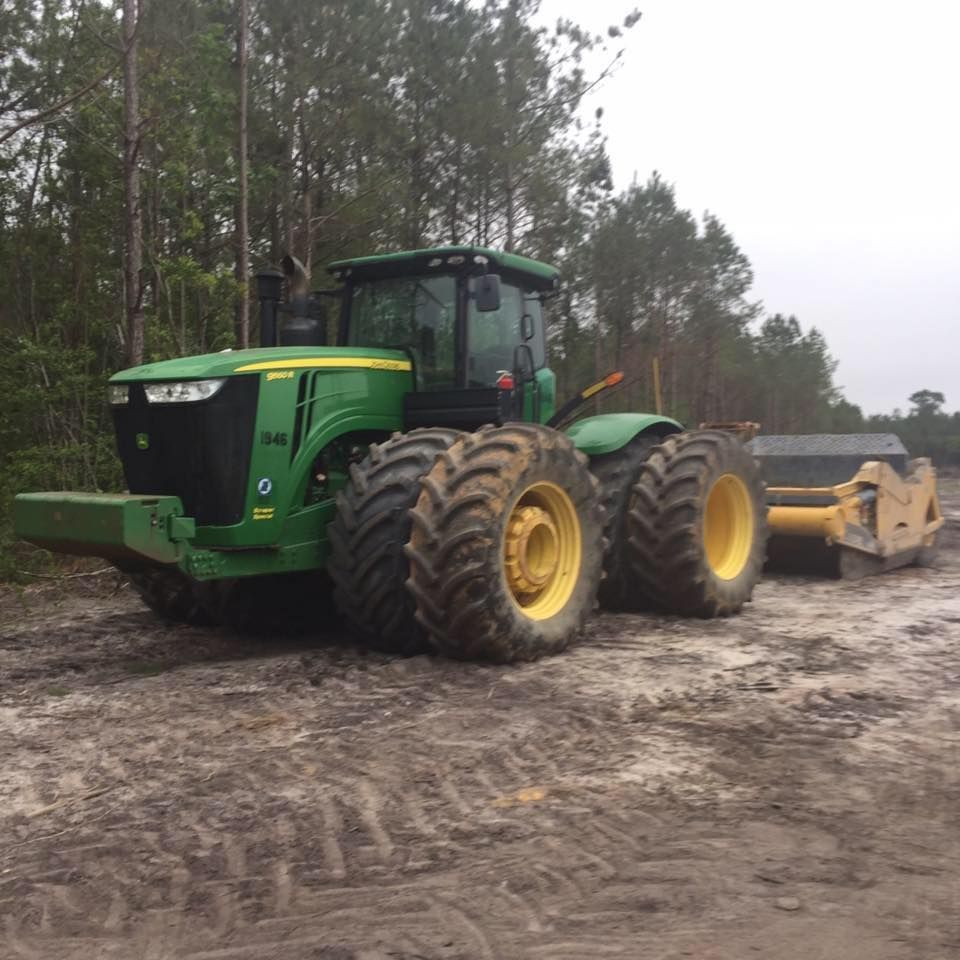 Green tractor grading land