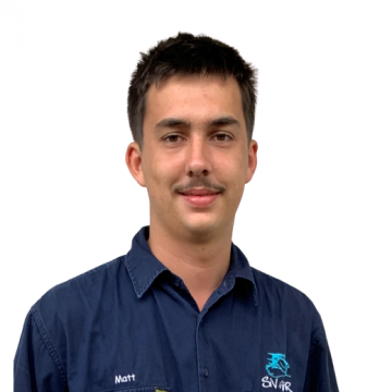 A man wearing a blue shirt with the name matt on it