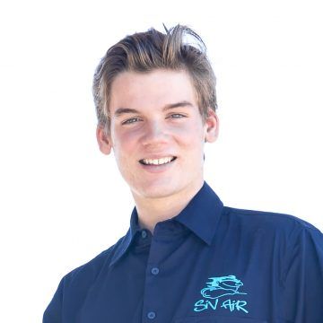 A young man wearing a blue shirt that says sn air