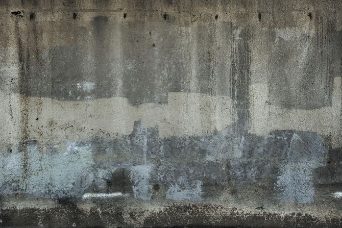 A close up of a concrete wall with a lot of stains on it