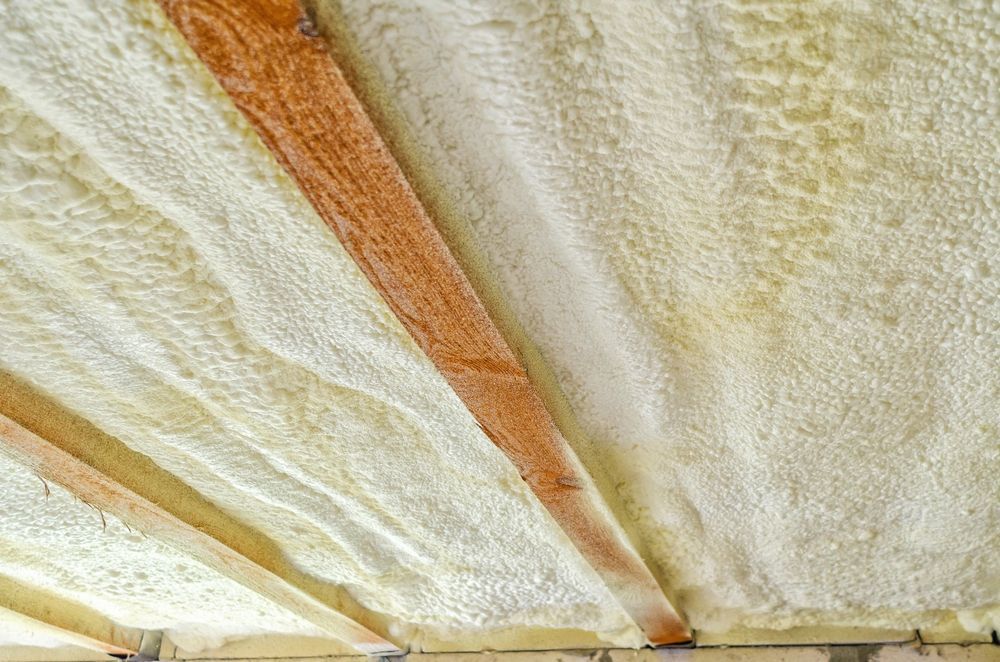 A close up of a ceiling with foam and wooden beams.