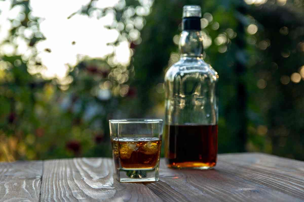 A Bourbon Whiskey Glass and Bottle on an Outdoor Table at Kentucky River Tours near Frankfort, KY