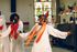 A group of men in white robes are dancing in a church