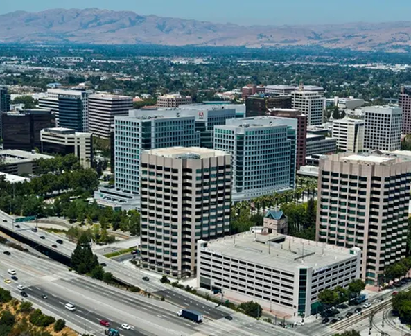 An aerial view of a city with mountains in the background