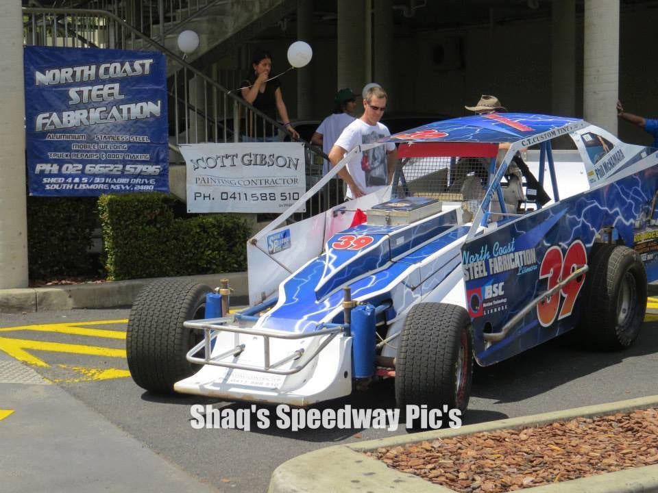 A Race Car is Parked in Front of a Sign That Says North Coast Steel Fabrication — North Coast Steel Fabrication in South Lismore, NSW