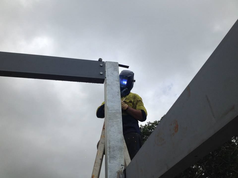 A Man Wearing a Welding Helmet is Working on a Metal Structure — North Coast Steel Fabrication in South Lismore, NSW