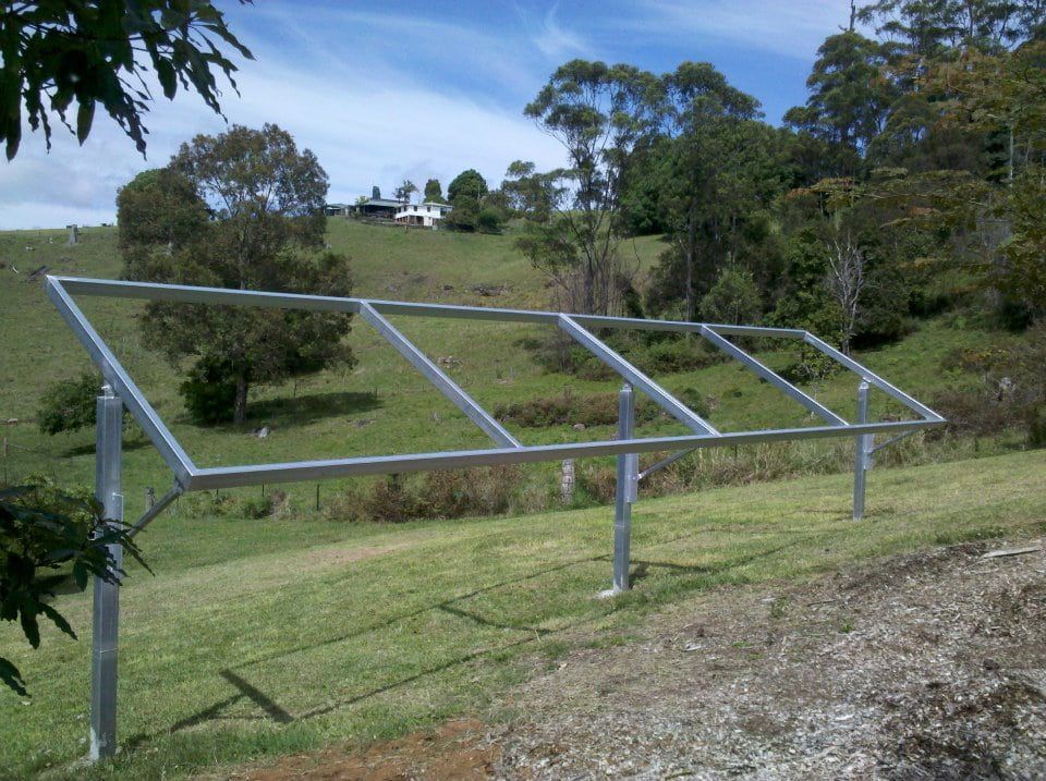 A Row of Solar Panels Frame Are Sitting in a Grassy Field — North Coast Steel Fabrication in South Lismore, NSW