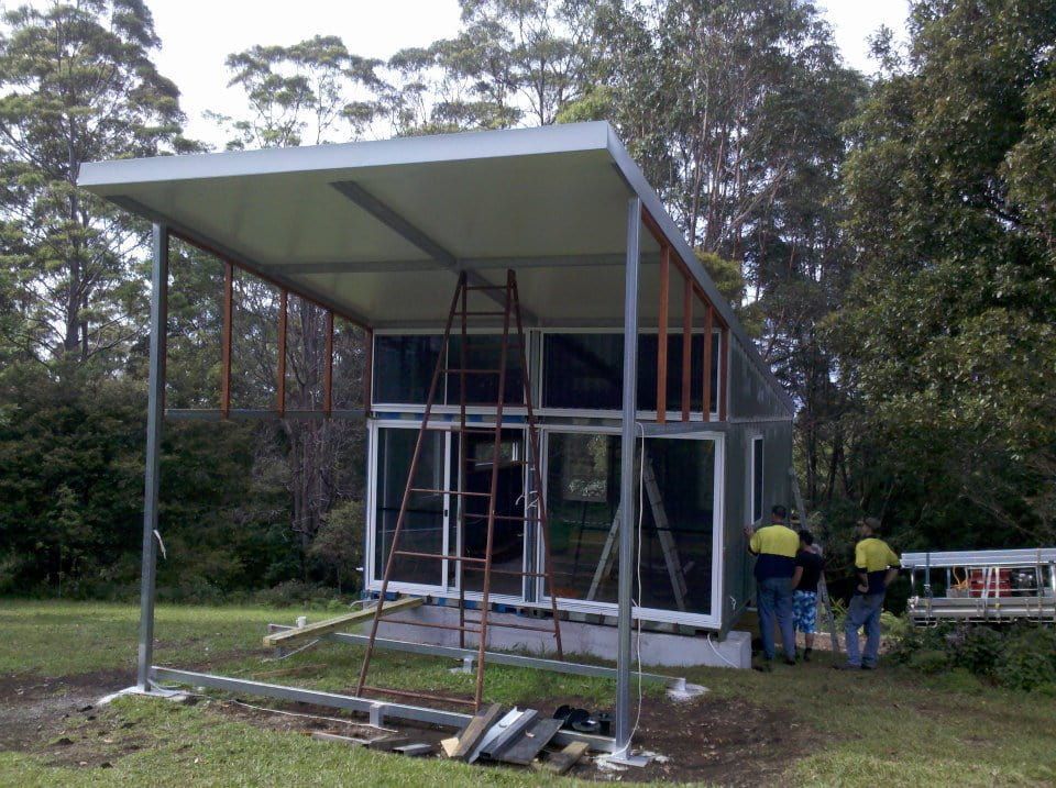 A Group of People Standing in Front of a Building Under Construction — North Coast Steel Fabrication in South Lismore, NSW