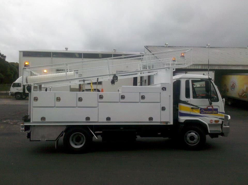A White Truck With a Ladder on the Back is Parked in a Parking Lot — North Coast Steel Fabrication in South Lismore, NSW