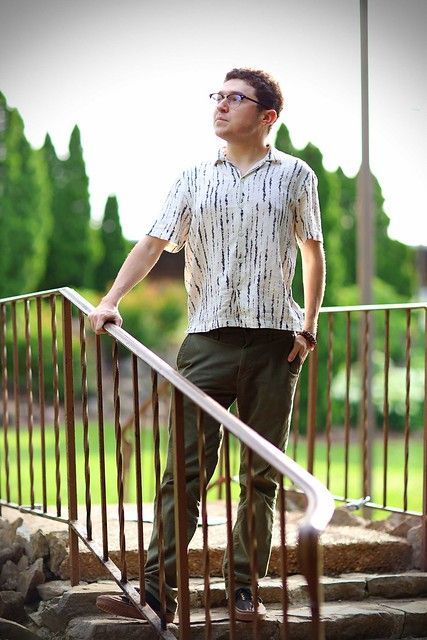 Dilynn standing on a set of stairs leaning on a railing