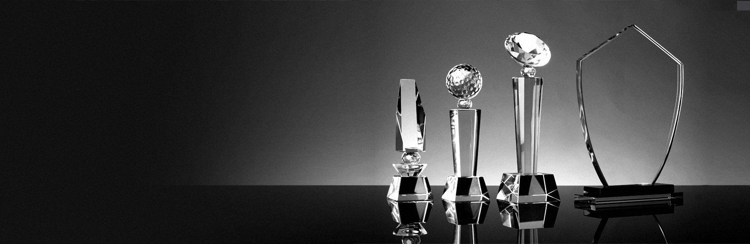 A group of crystal trophies are sitting on a table.