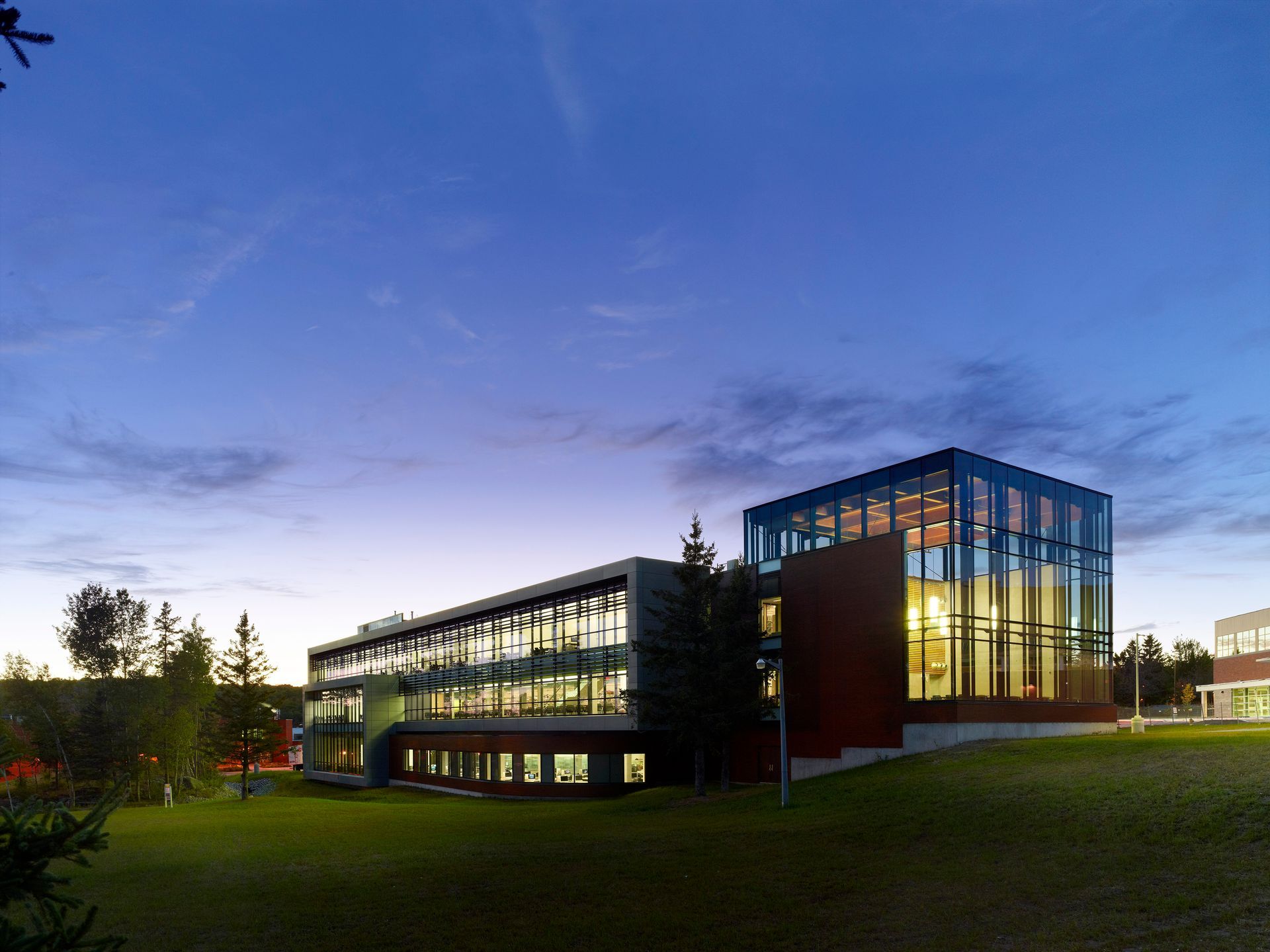 A large building with a lot of windows is lit up at night