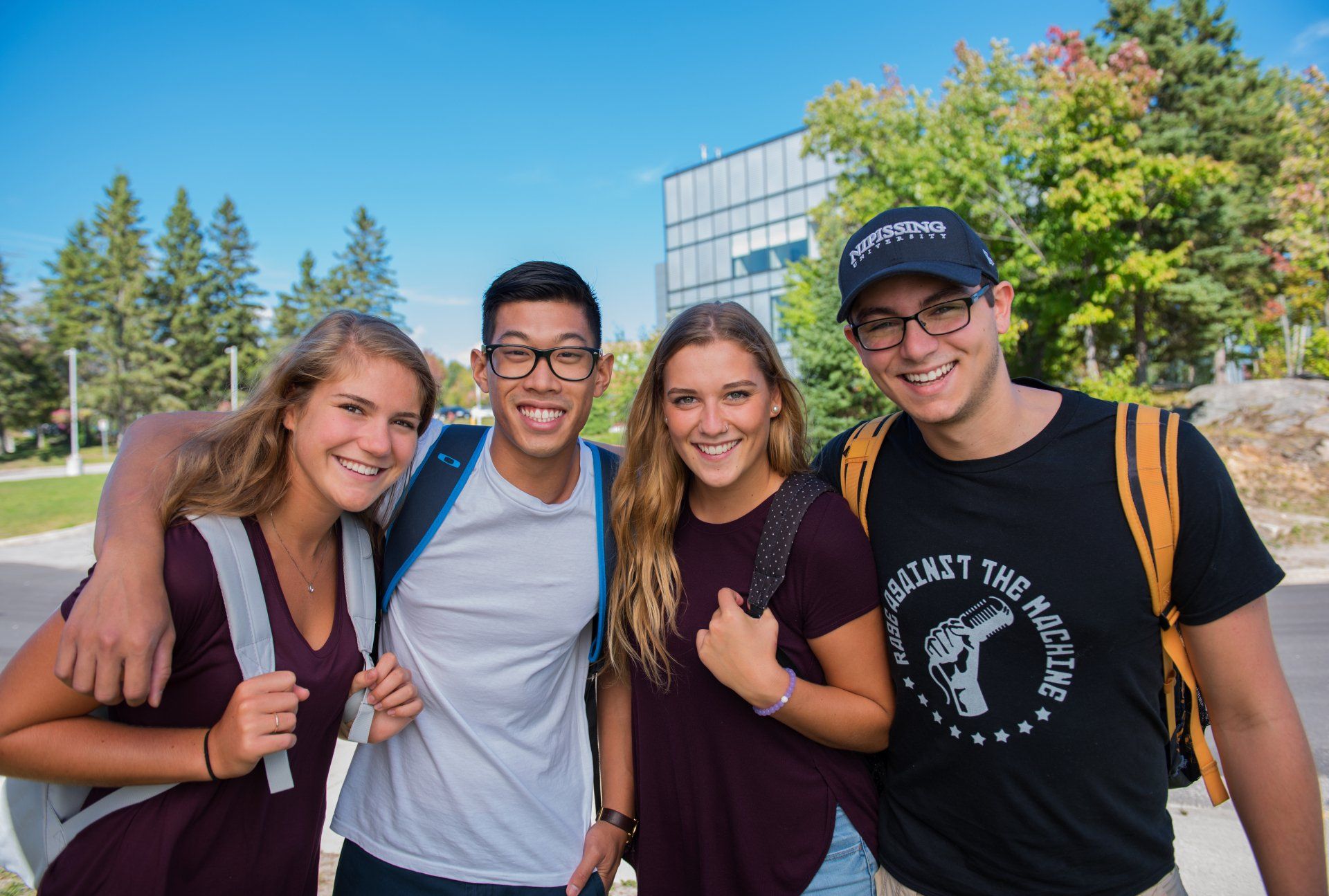 A group of young people are posing for a picture together.