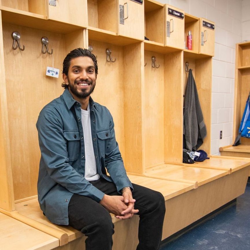 A student sitting in the locker room