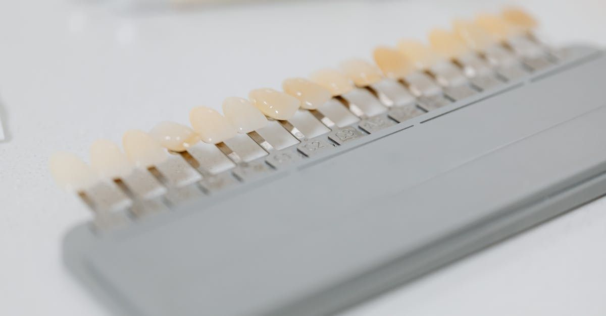 A dental shade guide with multiple teeth color samples in a row.