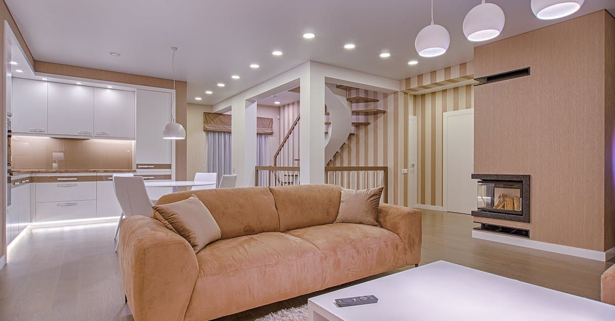 A living room with a brown couch and a white coffee table.