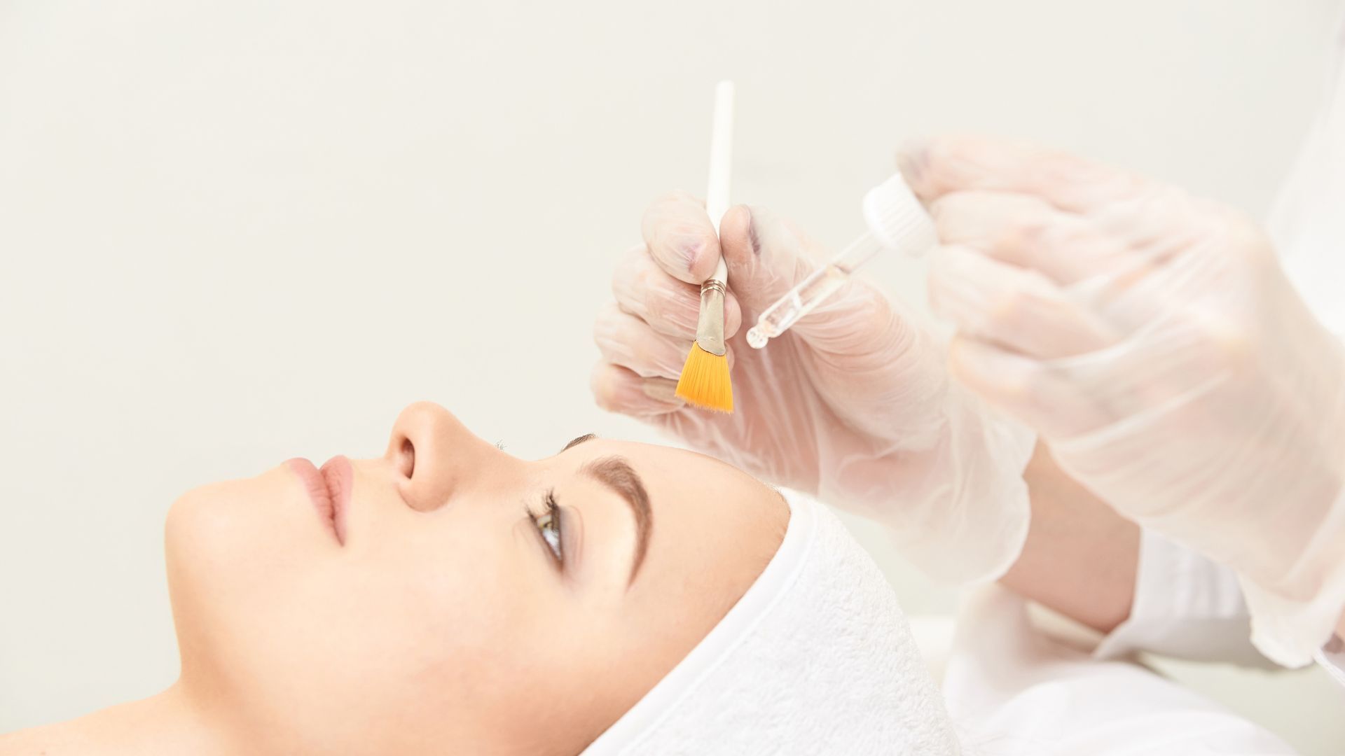 A woman is getting a facial treatment at a beauty salon.