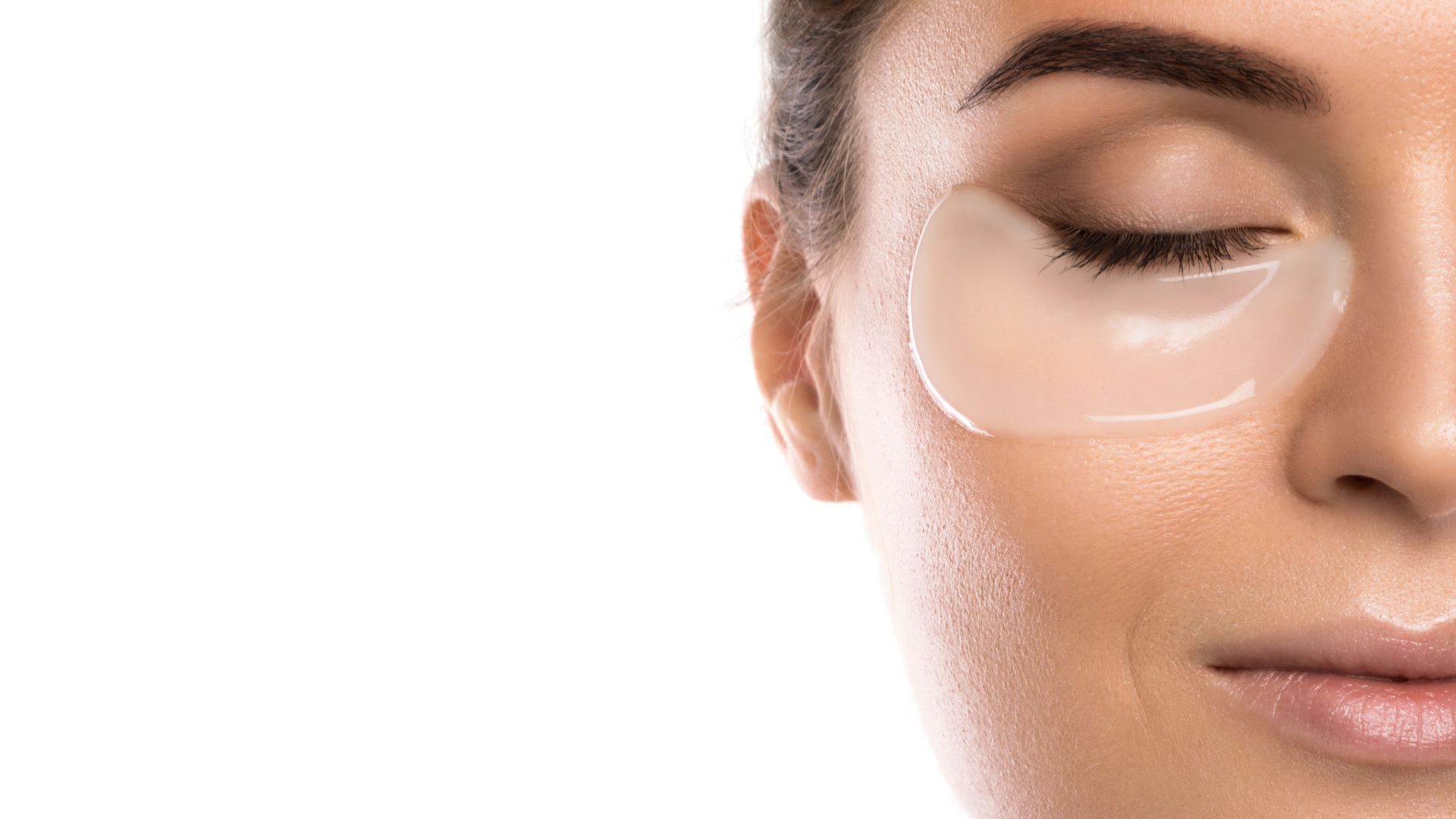 A close up of a woman 's face with eye patches on her eyes.