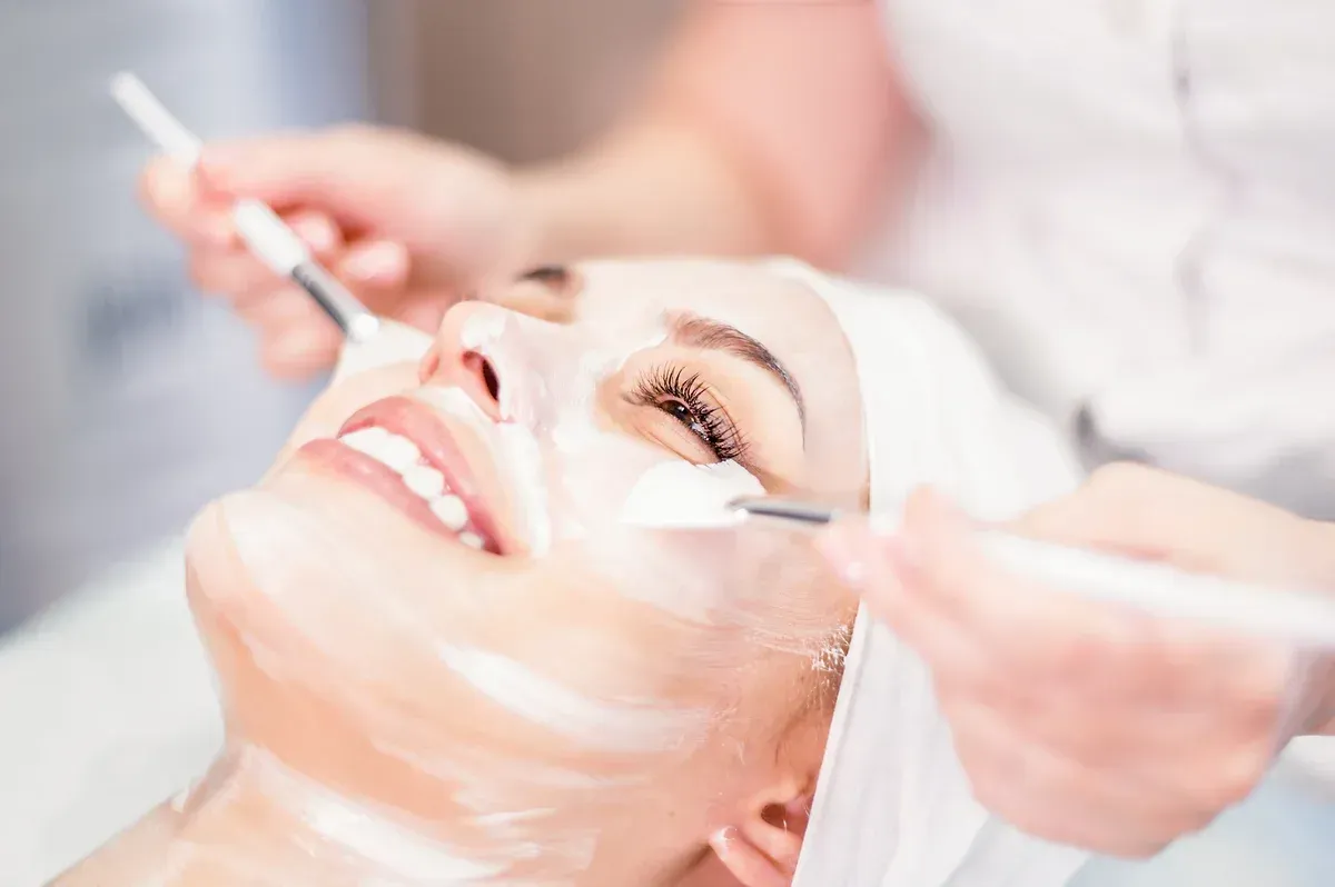 A woman is getting a facial treatment at a spa.