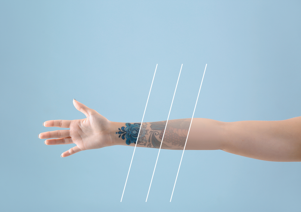 A woman 's arm with a tattoo on it against a blue background.