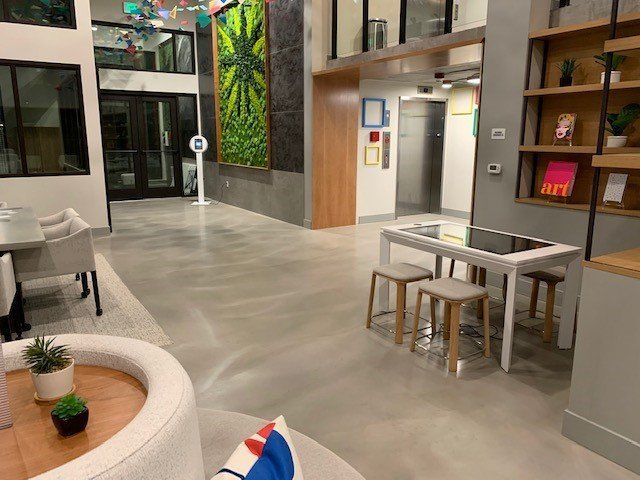 A living room with a table and chairs in it.