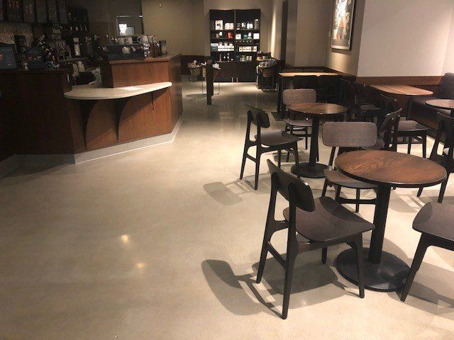 A restaurant with tables and chairs and a counter