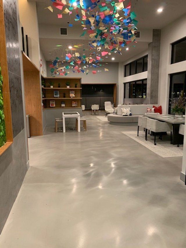 A large room with a lot of furniture and a colorful ceiling decoration.