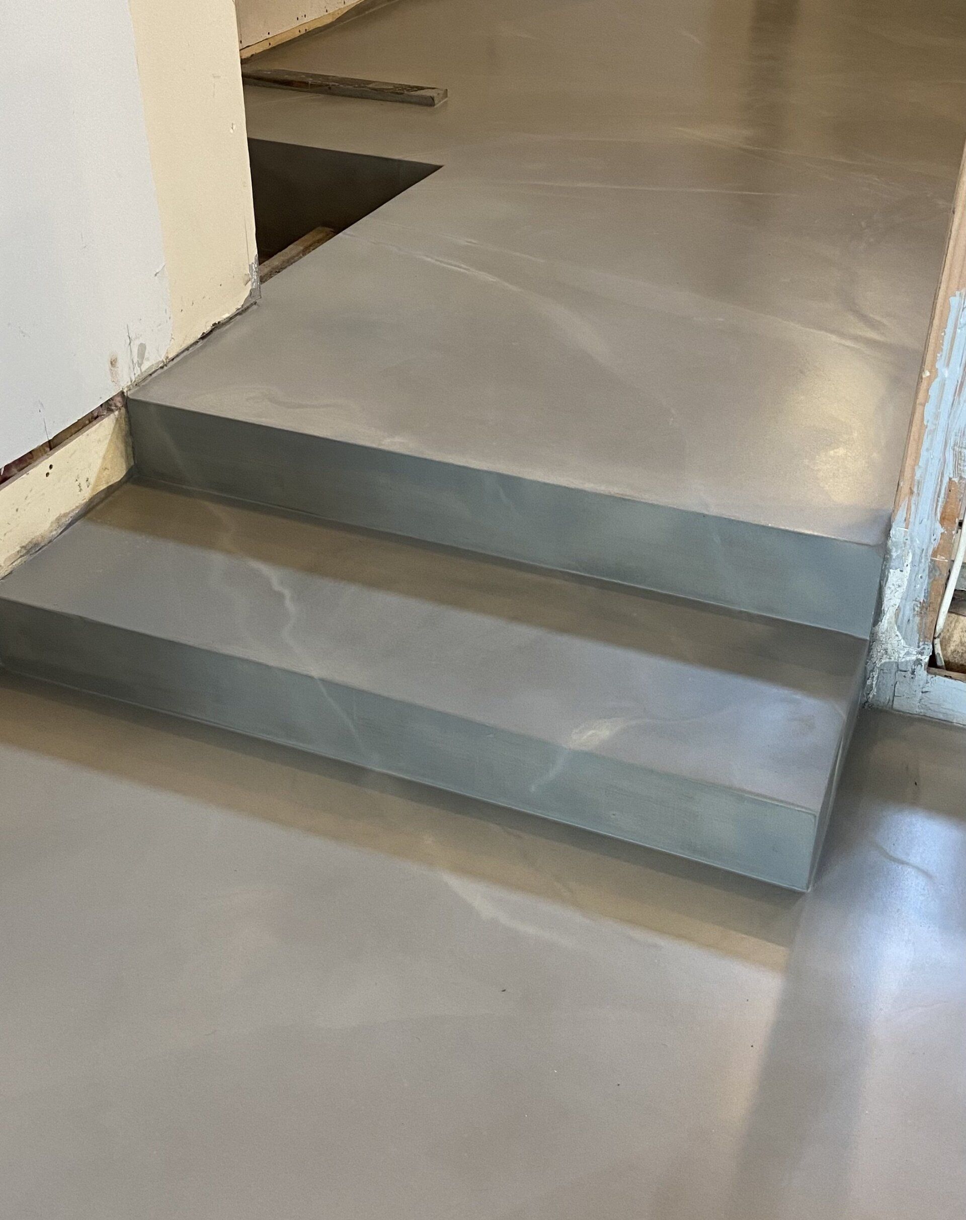 A close up of a set of stairs on a concrete floor.