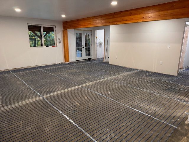 An empty room with a grid of wire on the floor