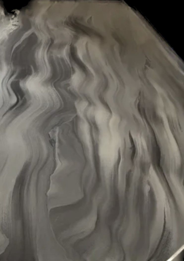 A close up of a gray and white marble texture on a table.