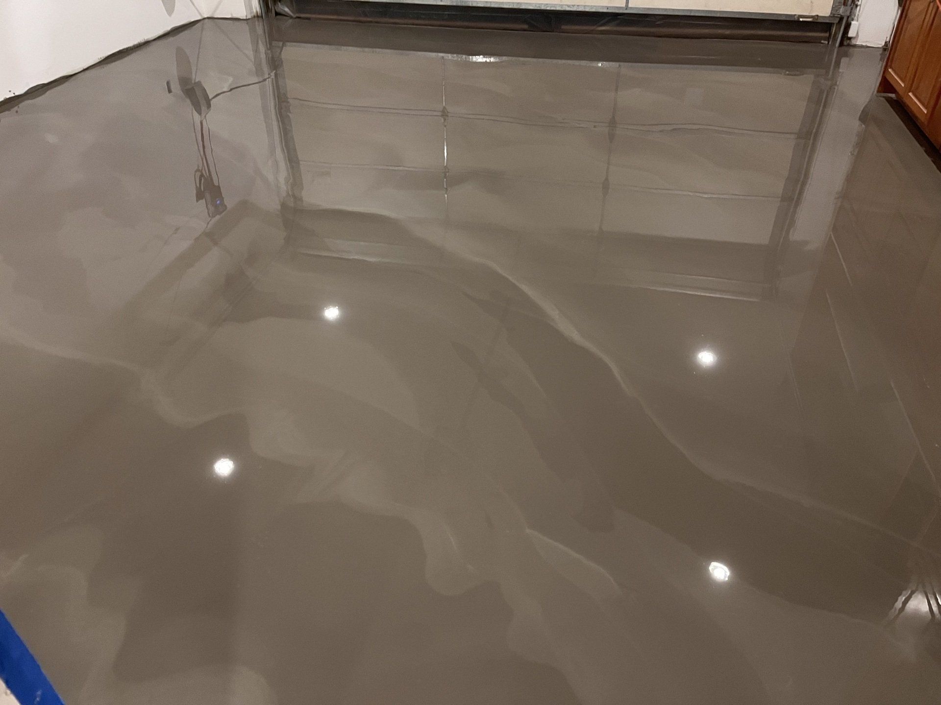 A close up of a shiny concrete floor in a room.