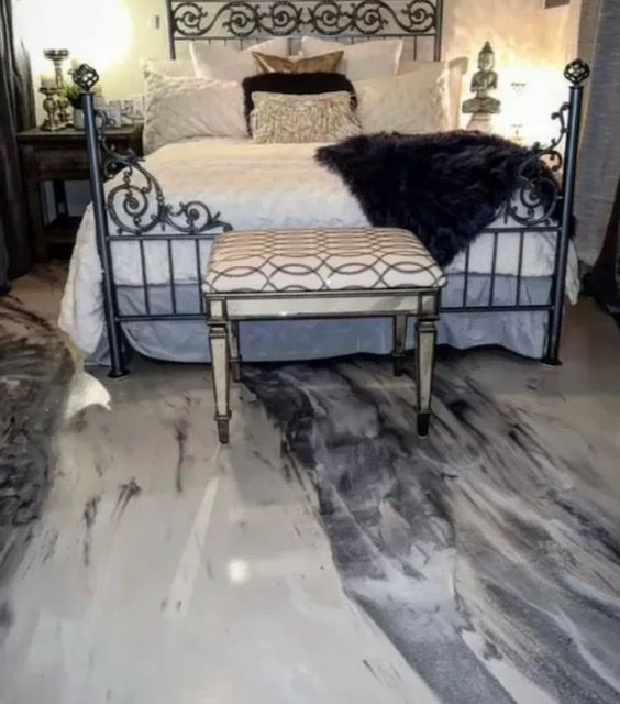 A bedroom with a bed and a bench on the floor