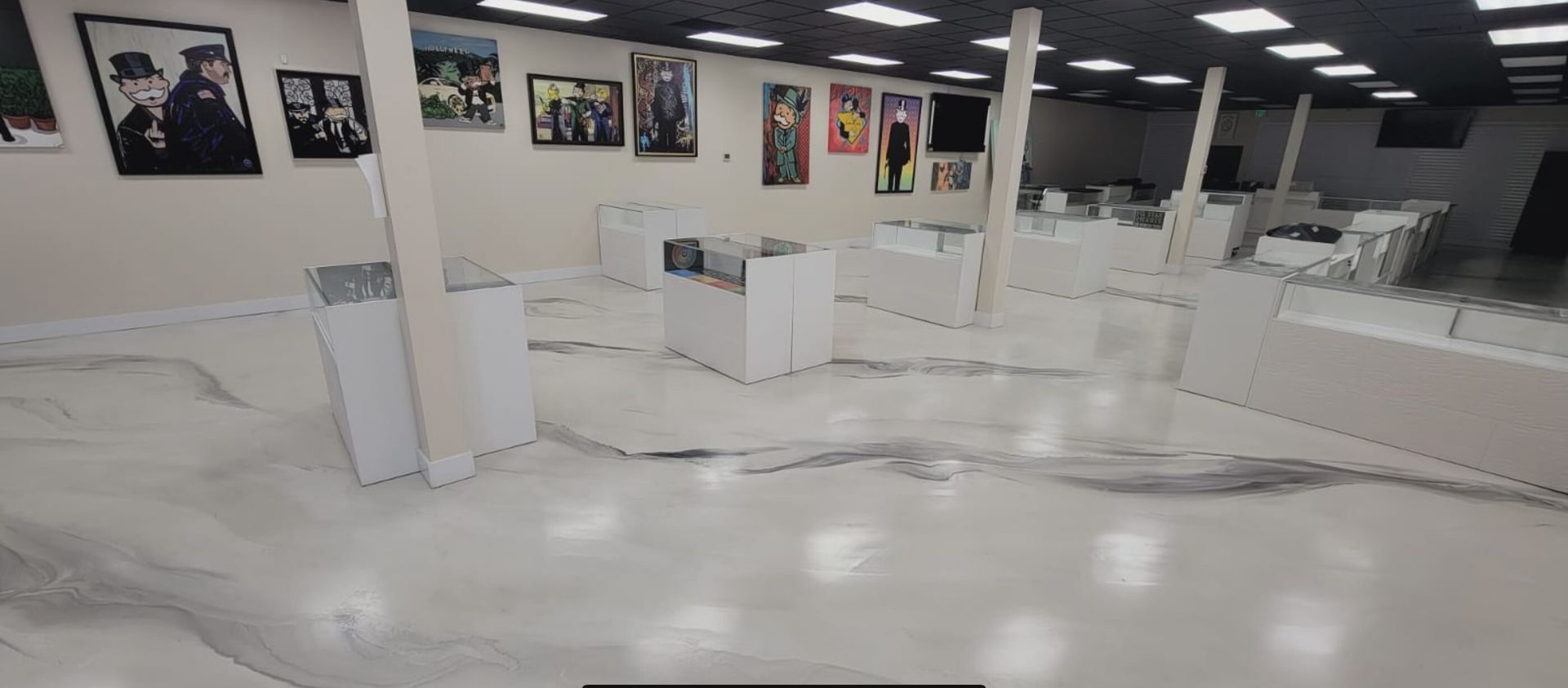 A large room with a white floor and a lot of pictures on the wall.