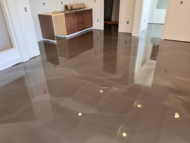 A room with a shiny floor and a cabinet in the background.