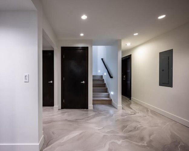 A hallway with stairs leading up to the second floor of a house.
