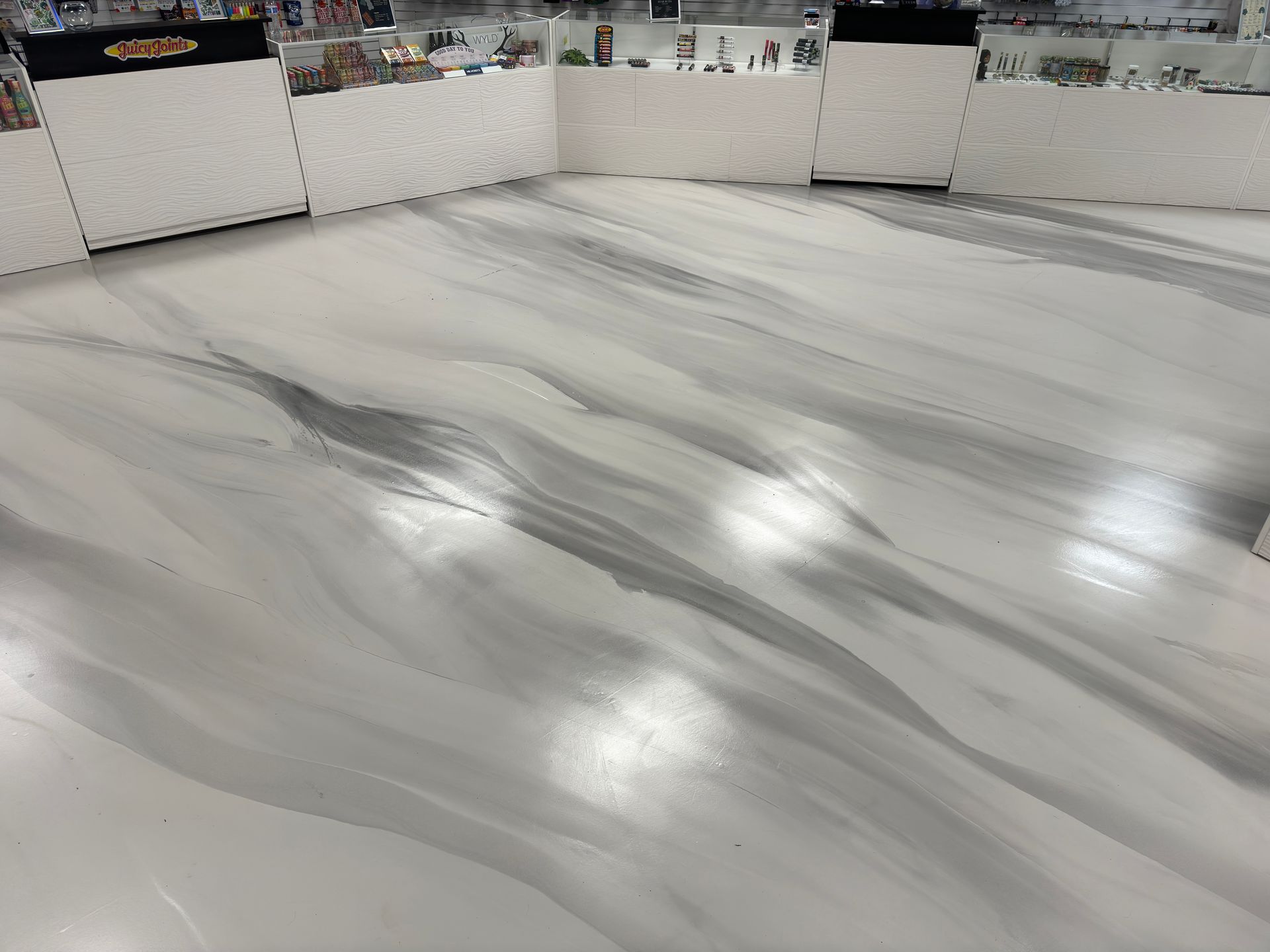 A white and gray marble floor in a store.
