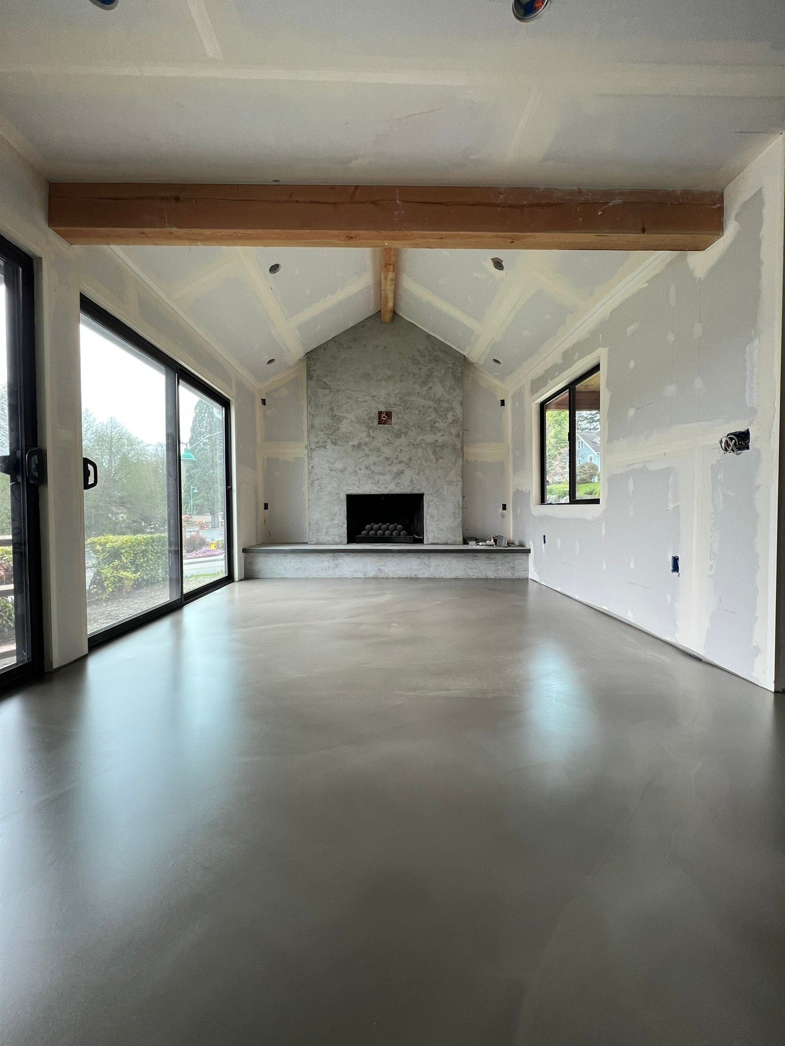 A living room with a fireplace and sliding glass doors.