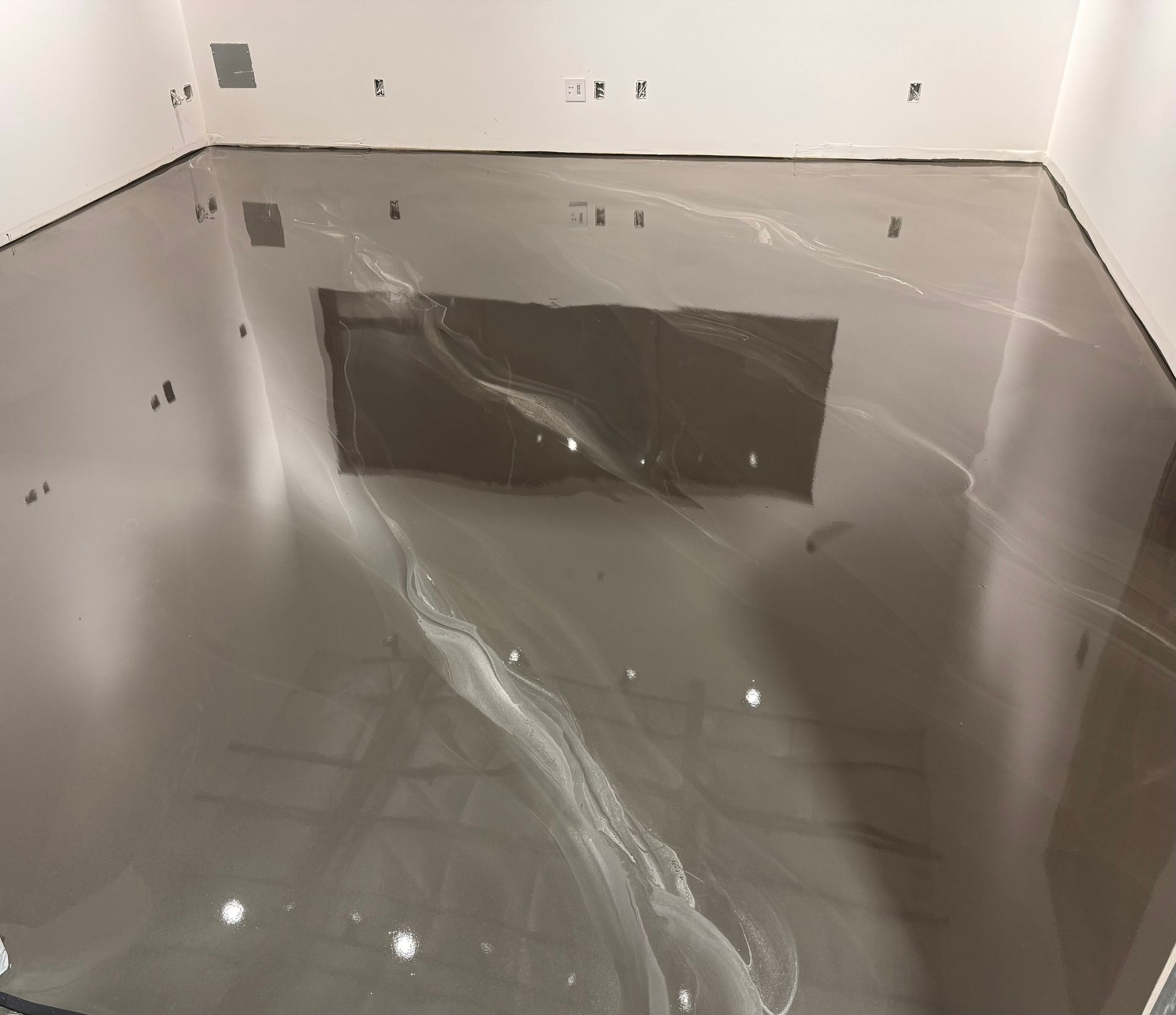 A room with a shiny floor and white walls.