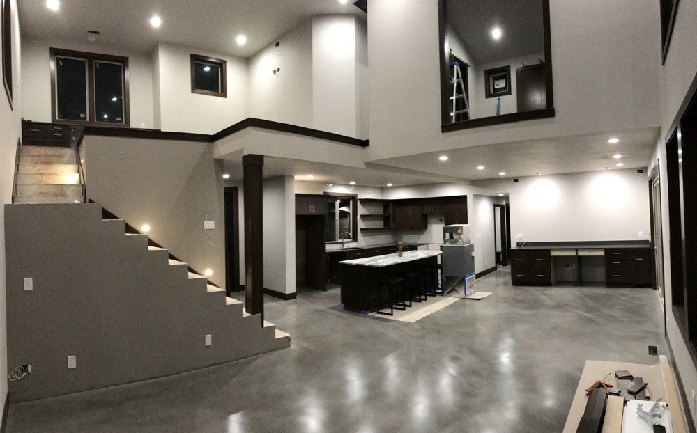 A large room with stairs leading up to the second floor