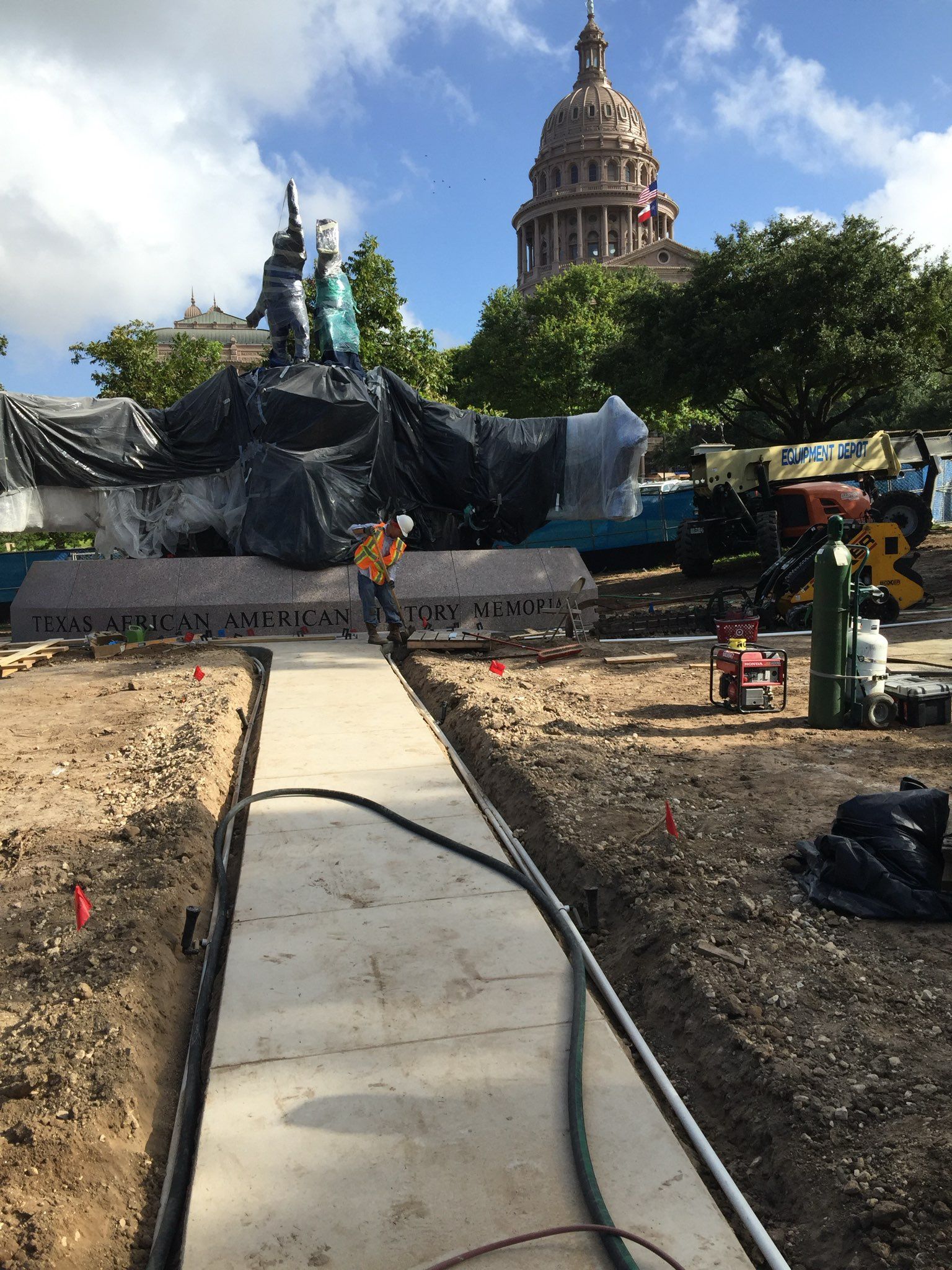 A concrete walkway is being built in front of the texas capitol building.