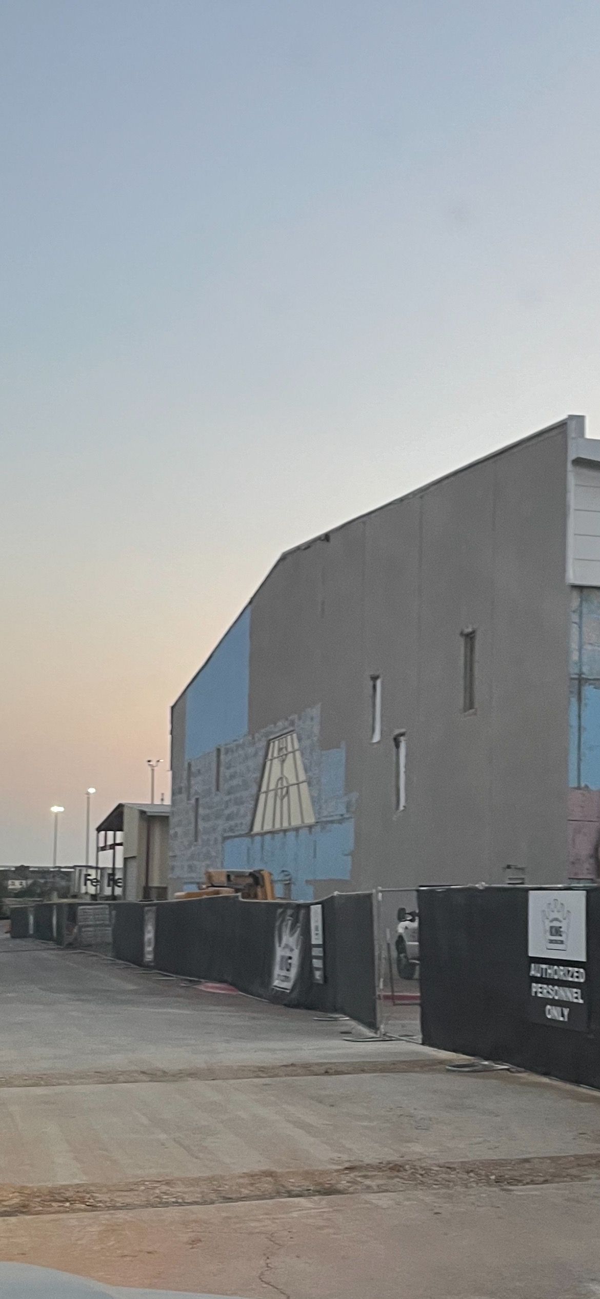 A large building with a lot of trucks parked in front of it.