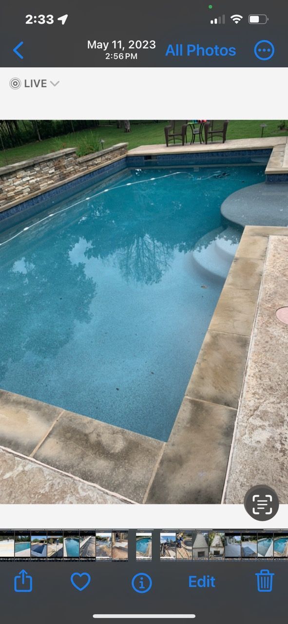 A phone screen shows a picture of a swimming pool.