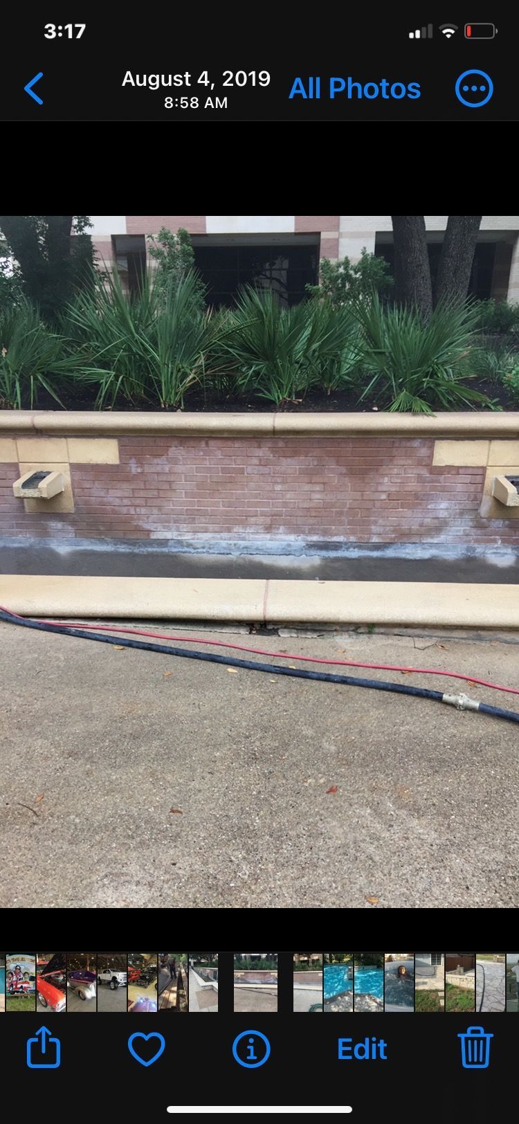 A phone screen shows a picture of a fountain before and after being cleaned.