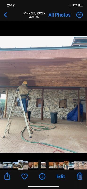 A man is sandblasting a piece of metal.