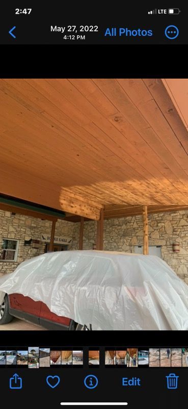 A phone screen shows a picture of a car covered in plastic.