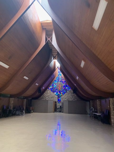 A large room with a stained glass window in the middle