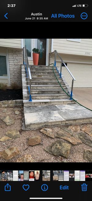 A phone screen shows a picture of a staircase with a hose attached to it.